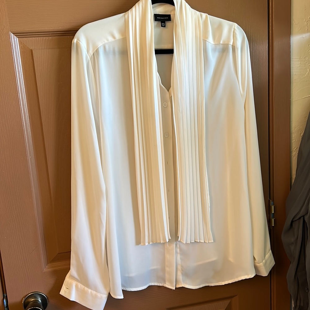 Ivory button down dress shirt with decorative tie.